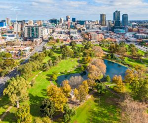 Aerial wide view east side of Adelaide with beautiful Rymill Park adjacent in foreground: vibrant green colours, sunny, connection between city and environment, wellbeing, recreation, conservation, autumn colours, fresh air. 4x3 format